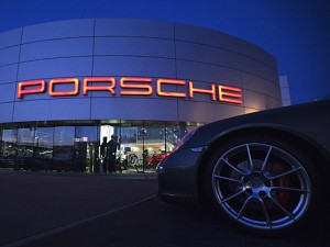 Illuminated Porsche logo is pictured on building of a Porsche retail centre in Niederwangen
